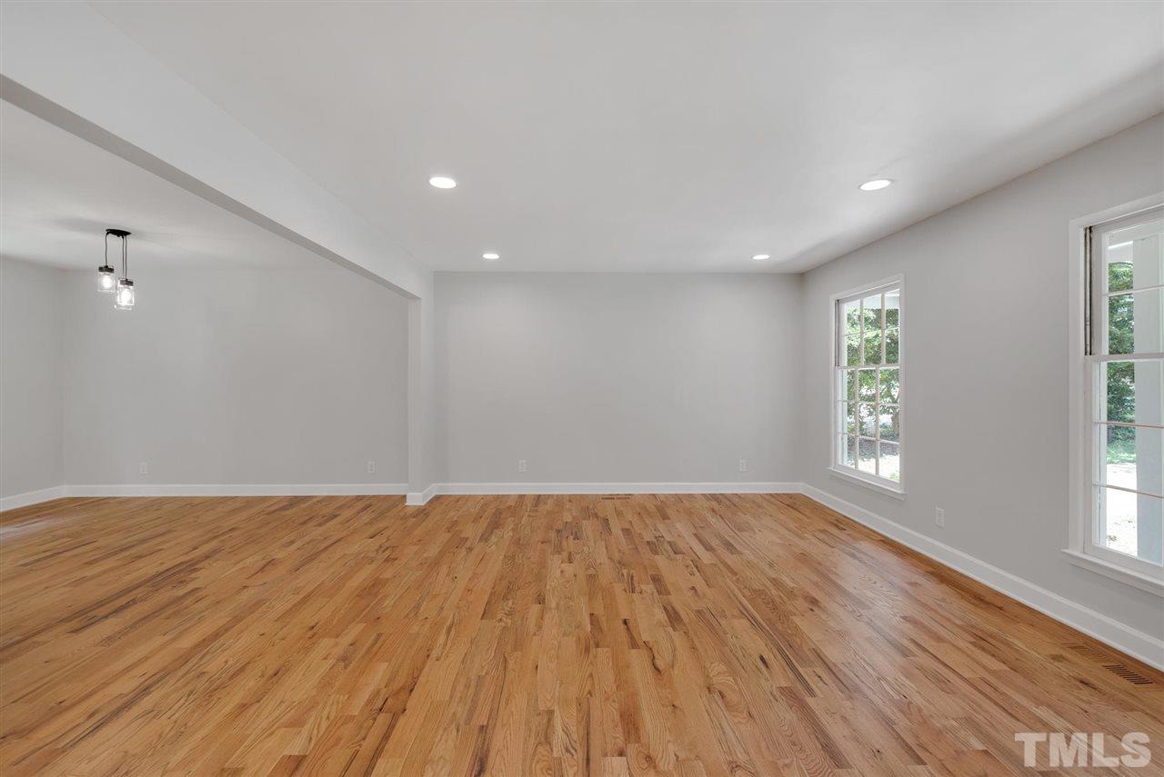 7409 Fiesta Way Raleigh, NC 27615 - Photo 10 of 30 a view of an empty room with wooden floor and window