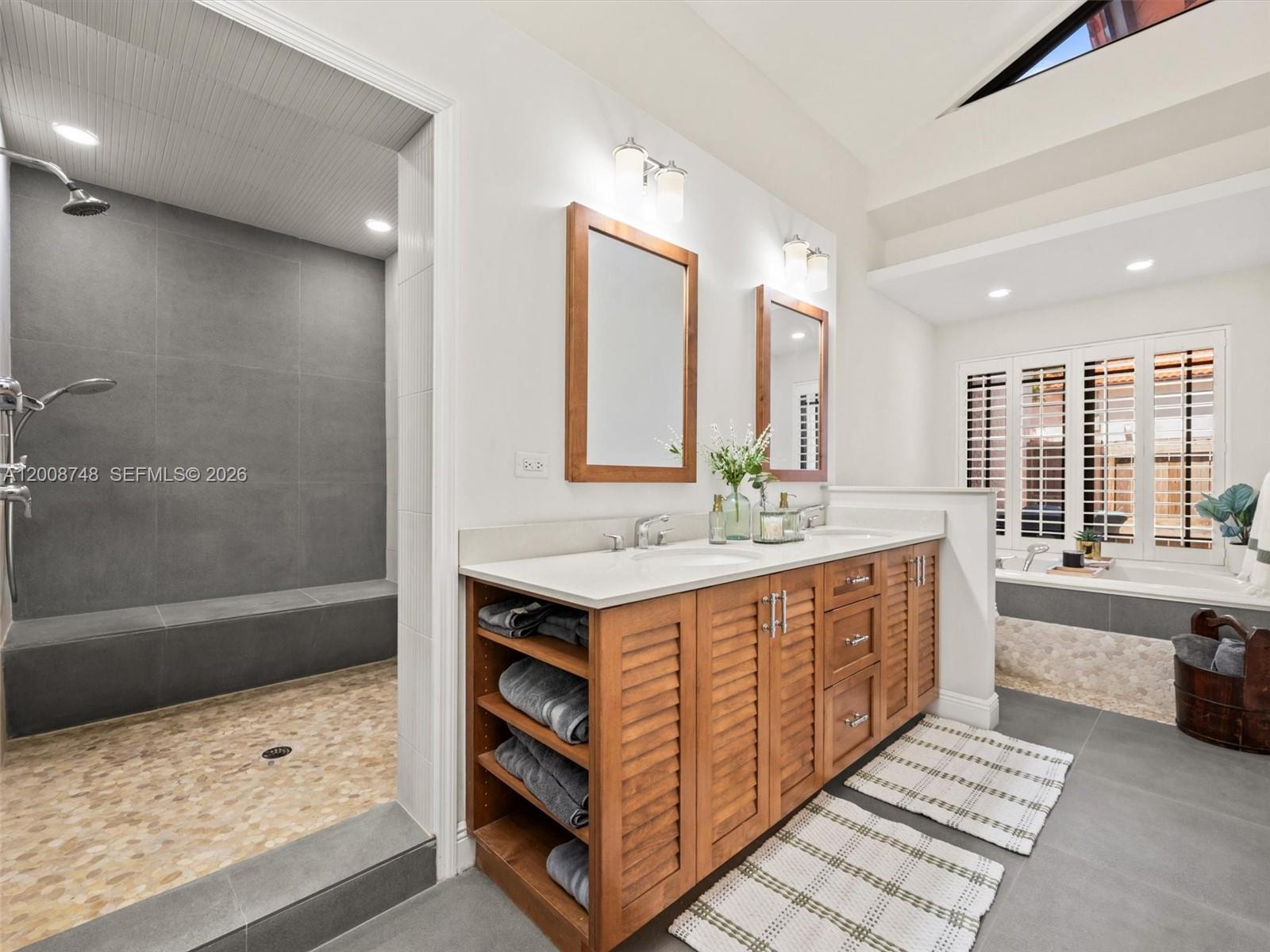 8889 Southwest 78th Court Miami, FL 33156 - Photo 11 of 23 a bathroom with a sink a mirror and a bathtub
