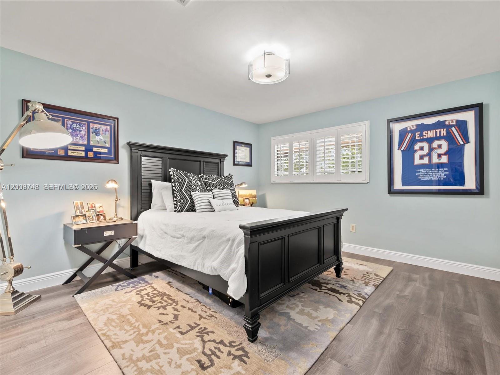 8889 Southwest 78th Court Miami, FL 33156 - Photo 12 of 23 a bed room with a bed and a painting on the wall