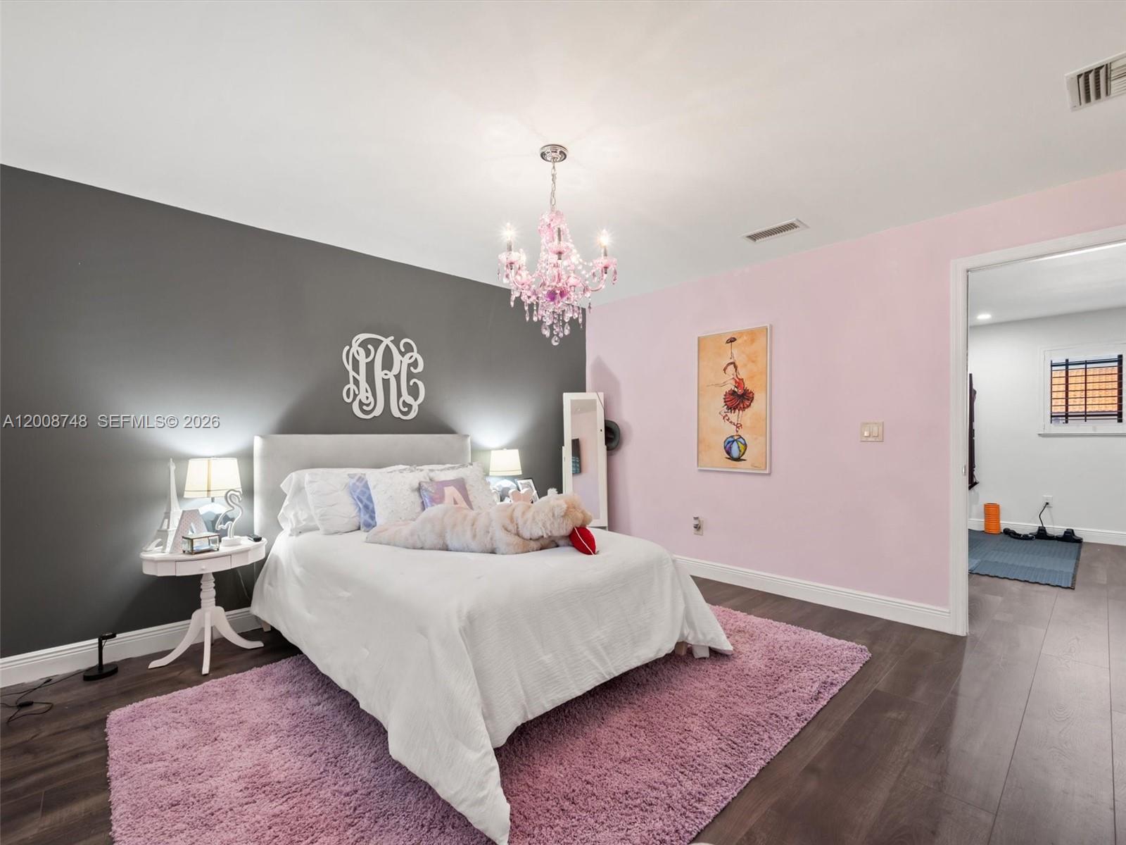 8889 Southwest 78th Court Miami, FL 33156 - Photo 16 of 23 a bedroom with a bed and a chandelier