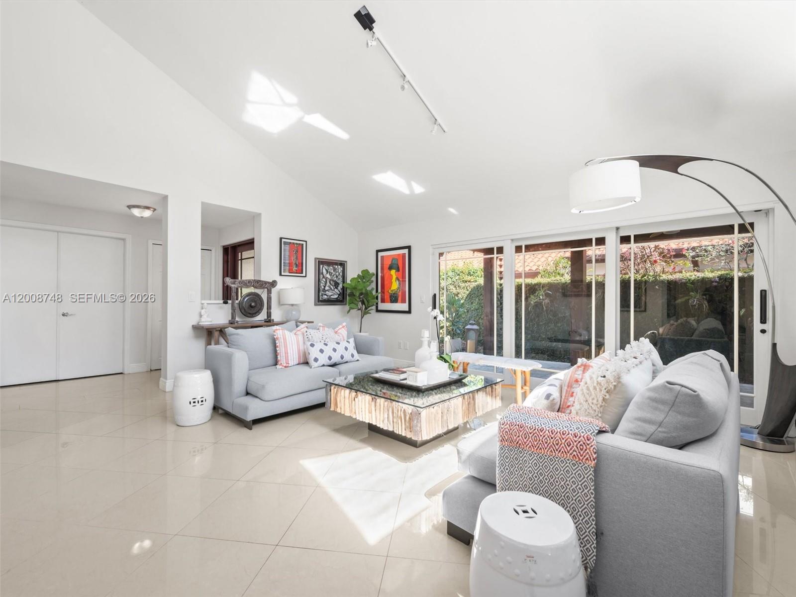 8889 Southwest 78th Court Miami, FL 33156 - Photo 2 of 23 a living room with furniture and a large window