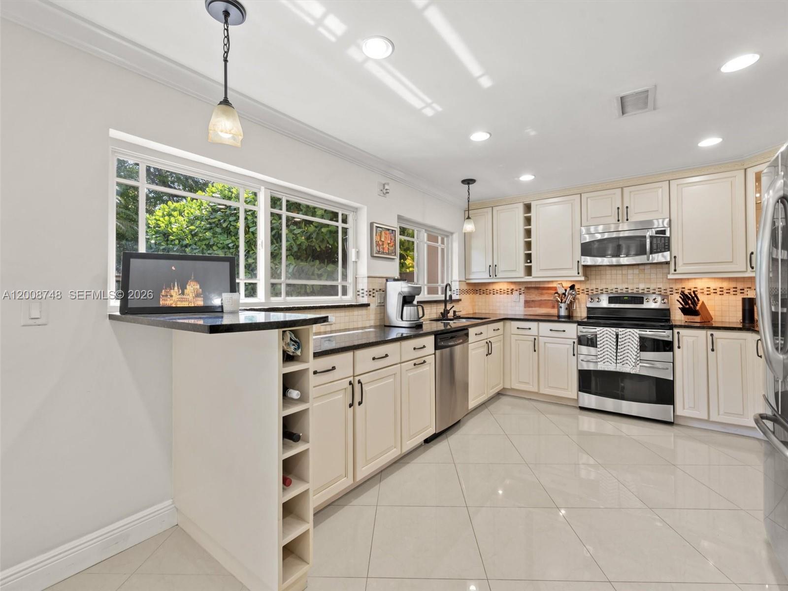 8889 Southwest 78th Court Miami, FL 33156 - Photo 5 of 23 a kitchen with stainless steel appliances granite countertop a stove and a refrigerator