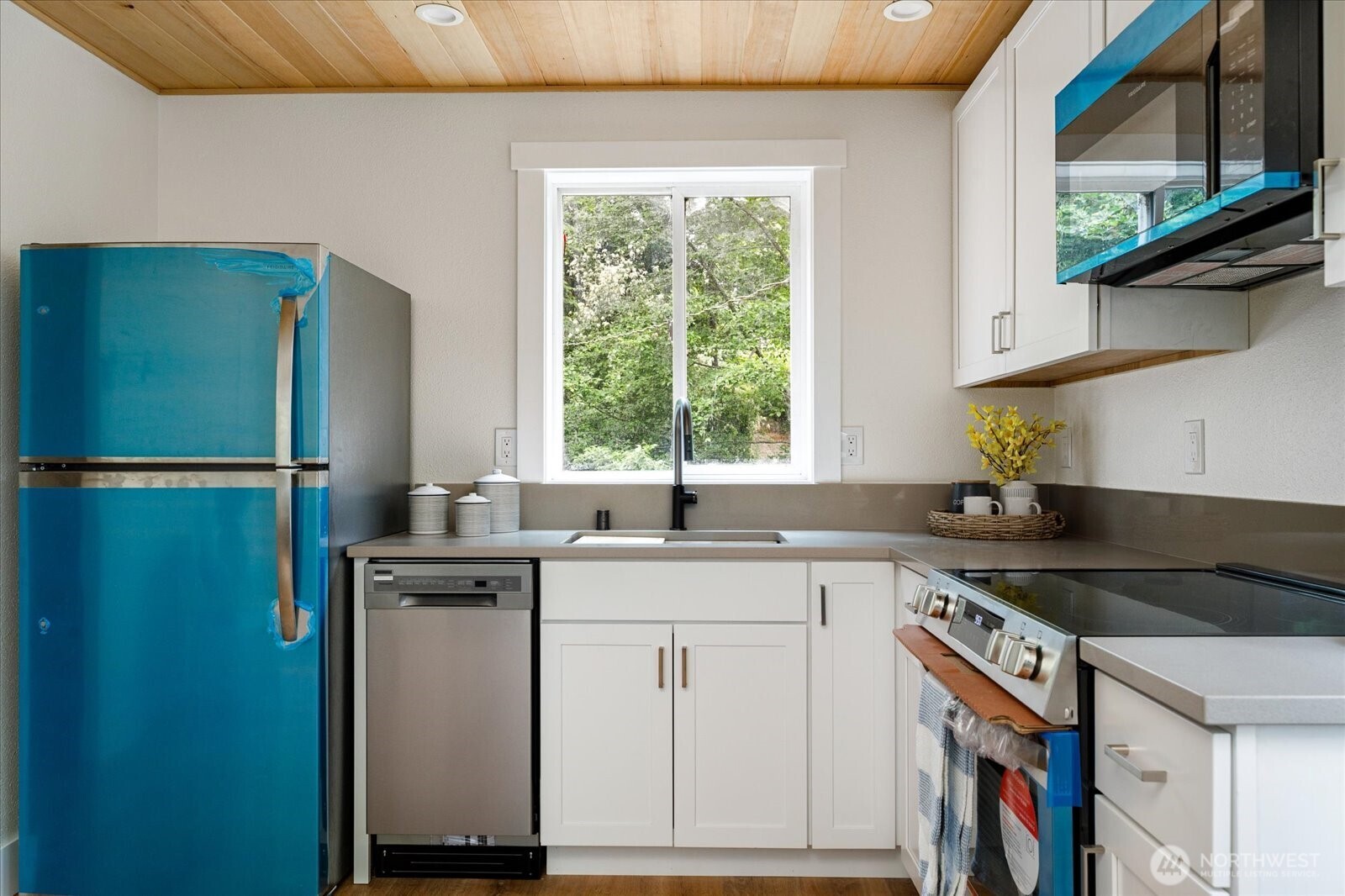 8038 Island Court Clinton, WA 98236 - Photo 11 of 23 a kitchen with a sink and cabinets