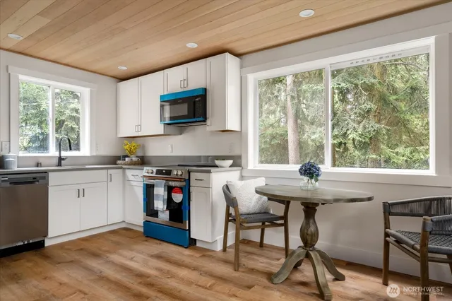 a kitchen with stainless steel appliances granite countertop a stove and a sink