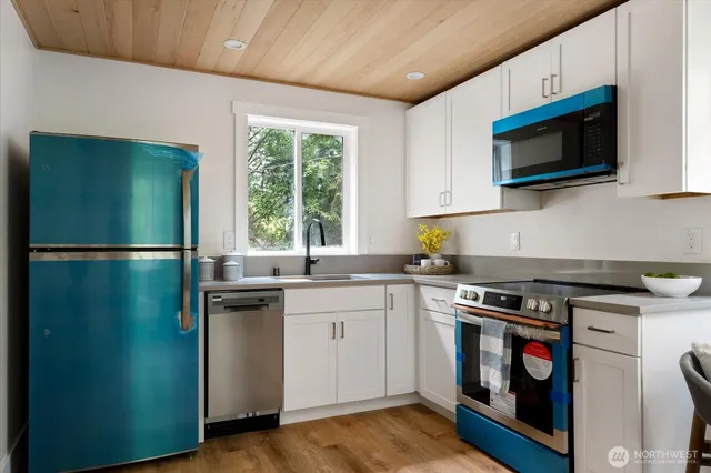 a kitchen with a stove and a microwave
