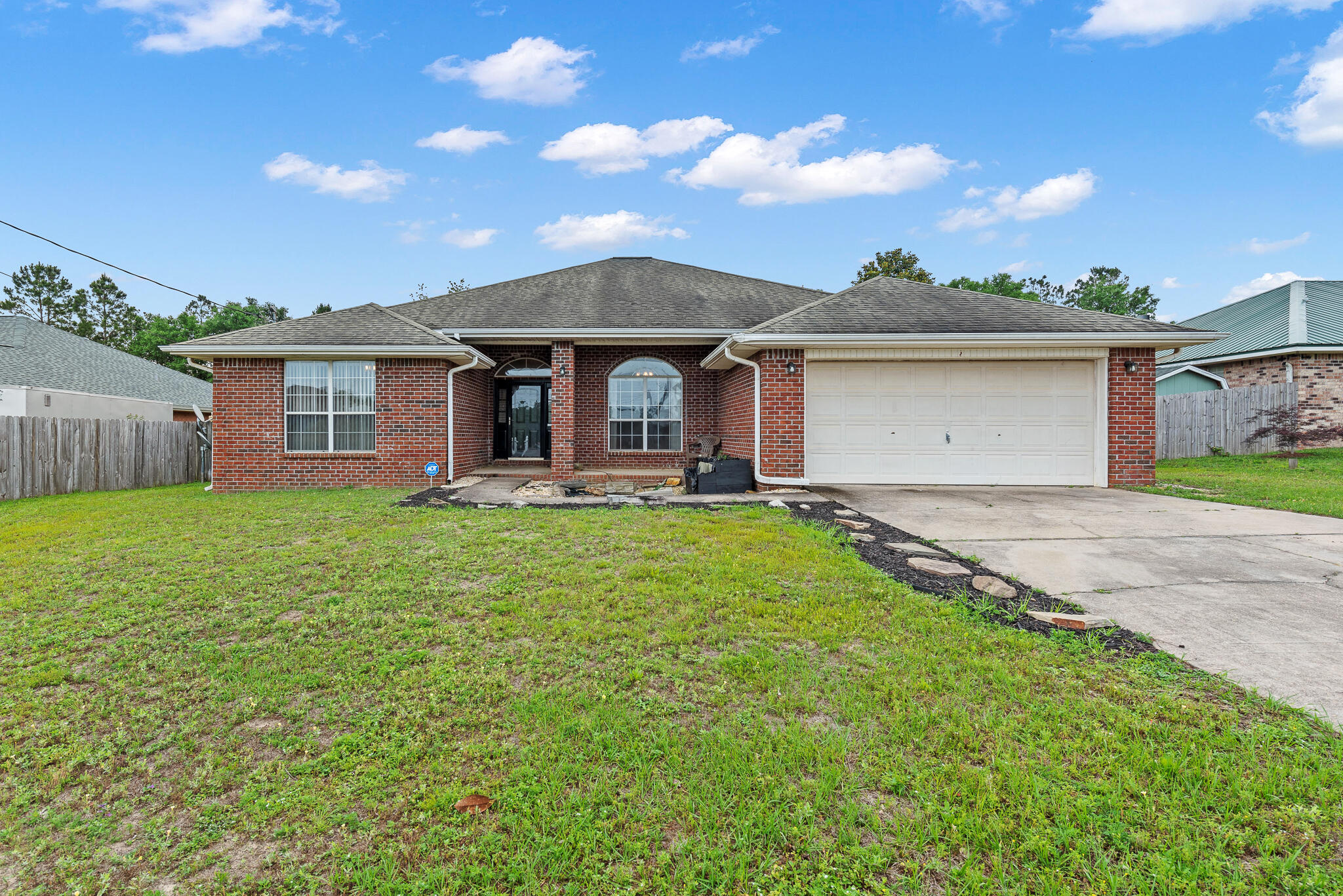 a front view of house with yard and green space