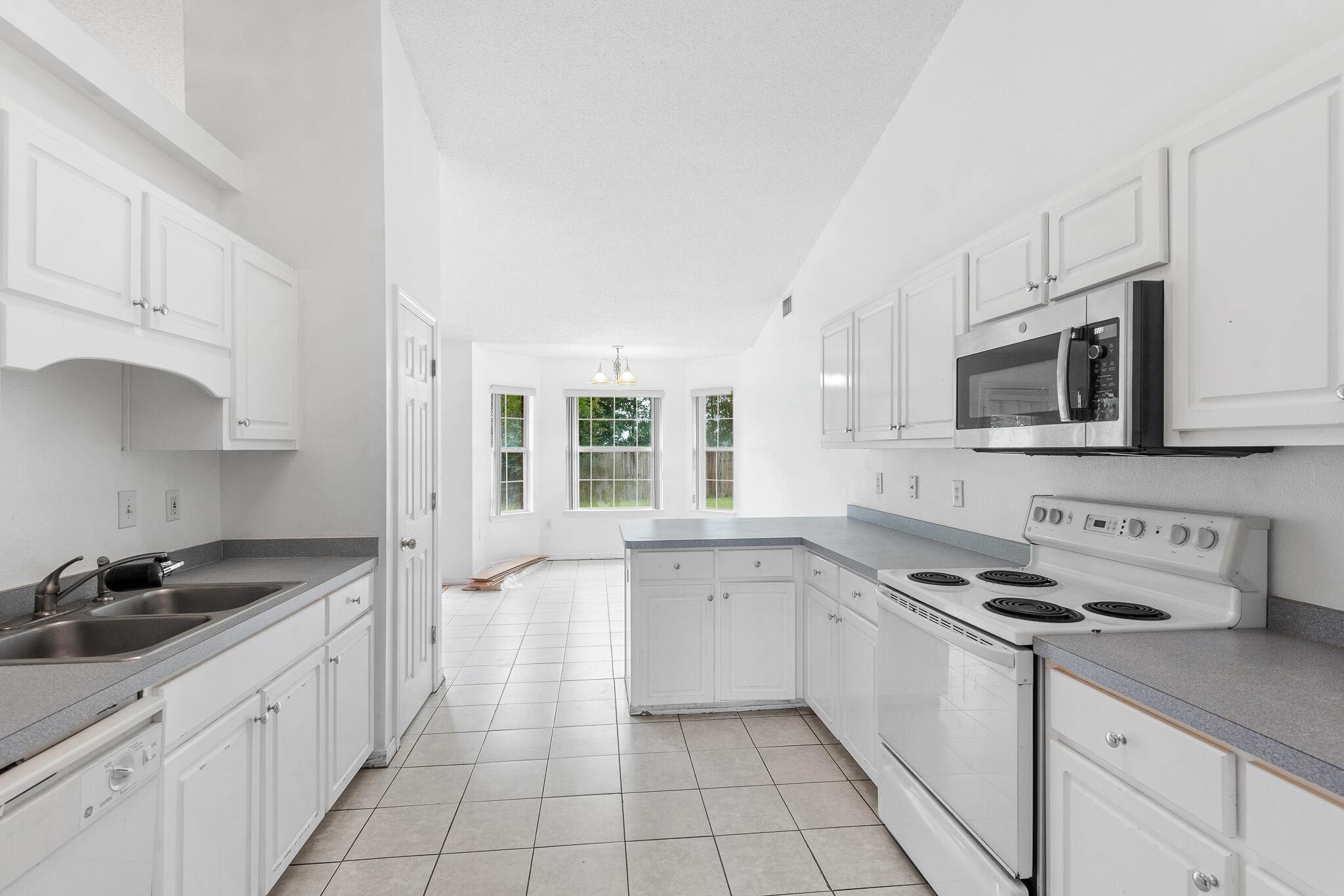 2246 Titanium Drive Crestview, FL 32536 - Photo 12 of 28 a kitchen with stainless steel appliances a sink stove top oven and microwave