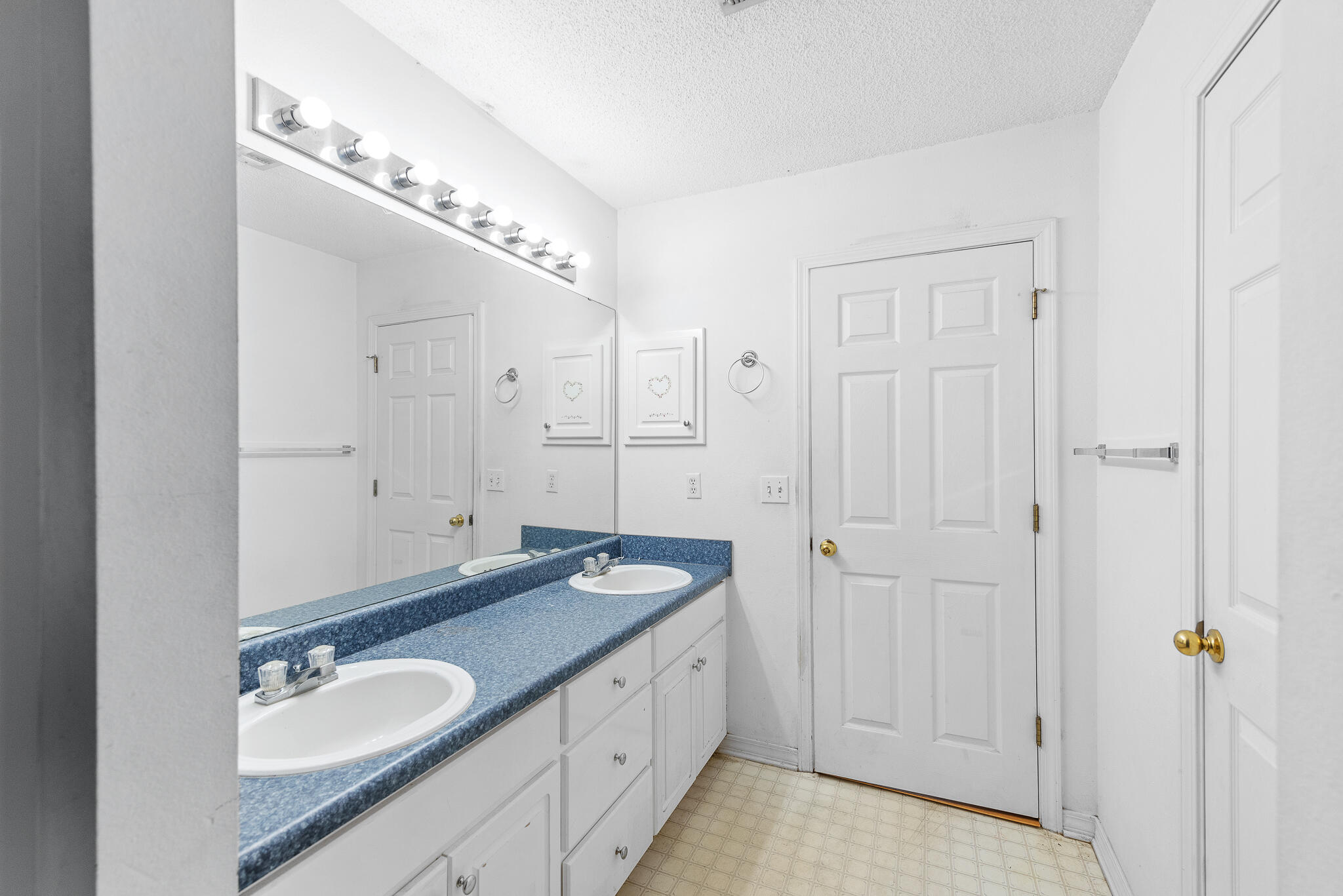2246 Titanium Drive Crestview, FL 32536 - Photo 18 of 28 a spacious bathroom with a granite countertop sink and a mirror