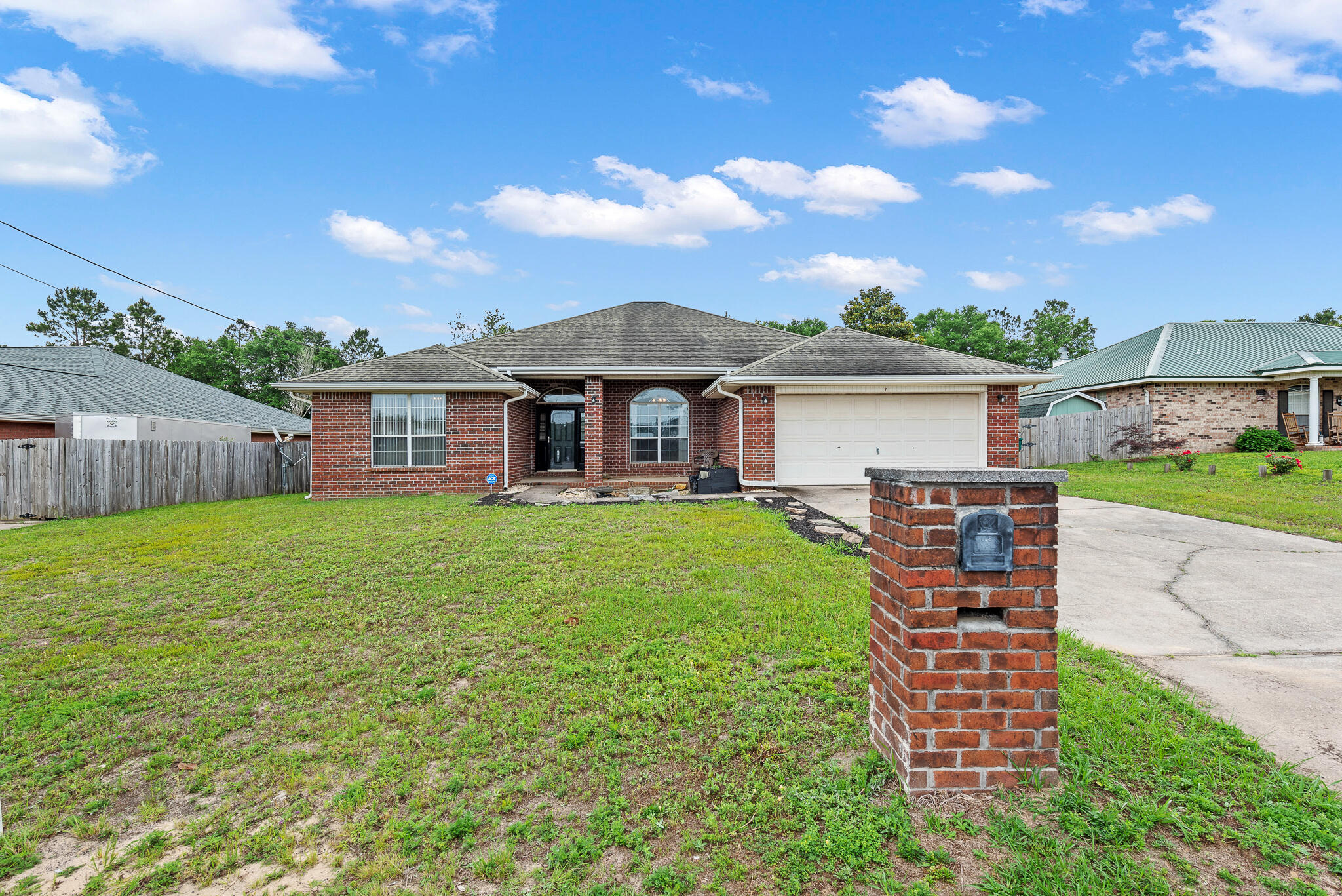 2246 Titanium Drive Crestview, FL 32536 - Photo 2 of 28 a front view of a house with a garden