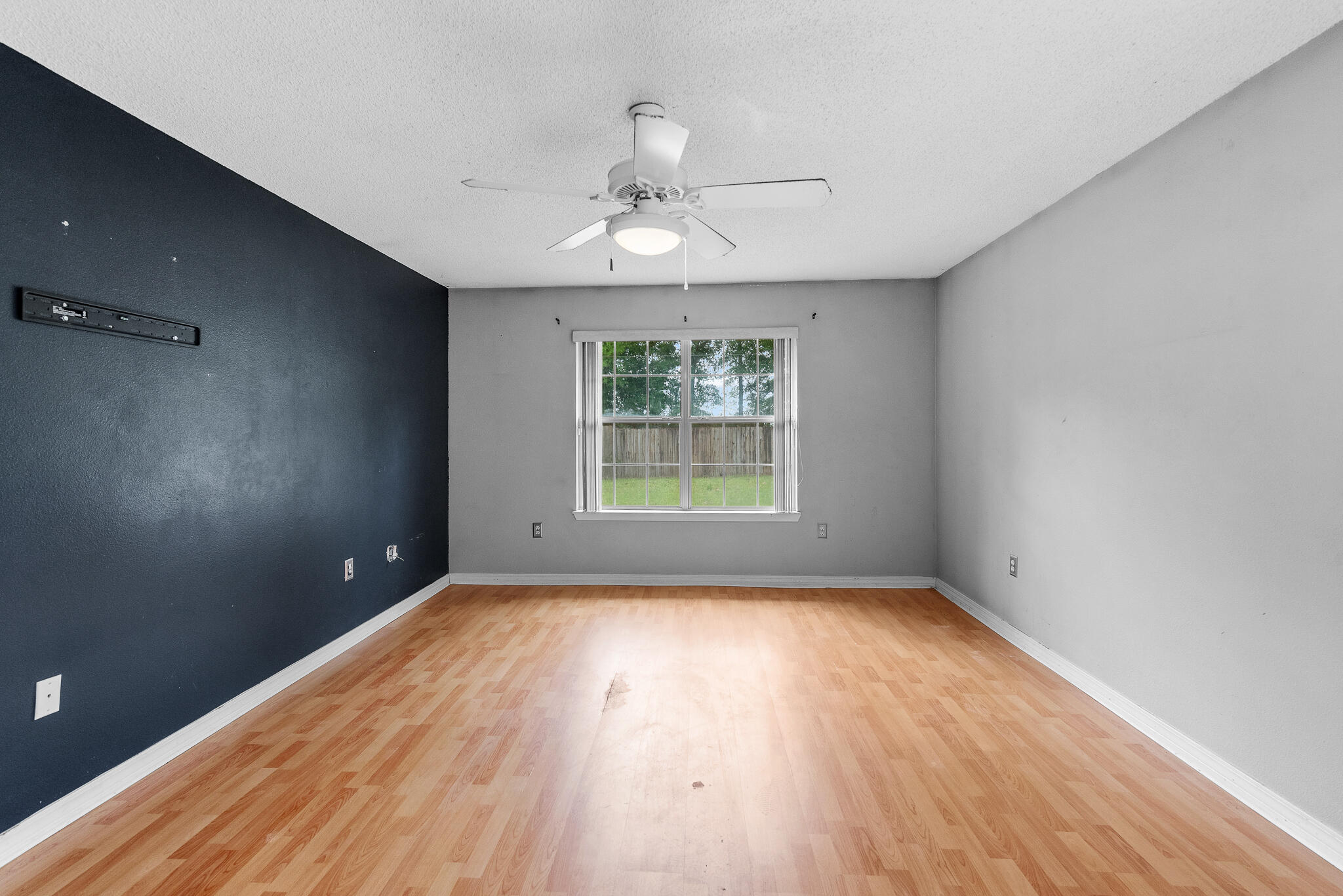 2246 Titanium Drive Crestview, FL 32536 - Photo 21 of 28 wooden floor in an empty room with a window
