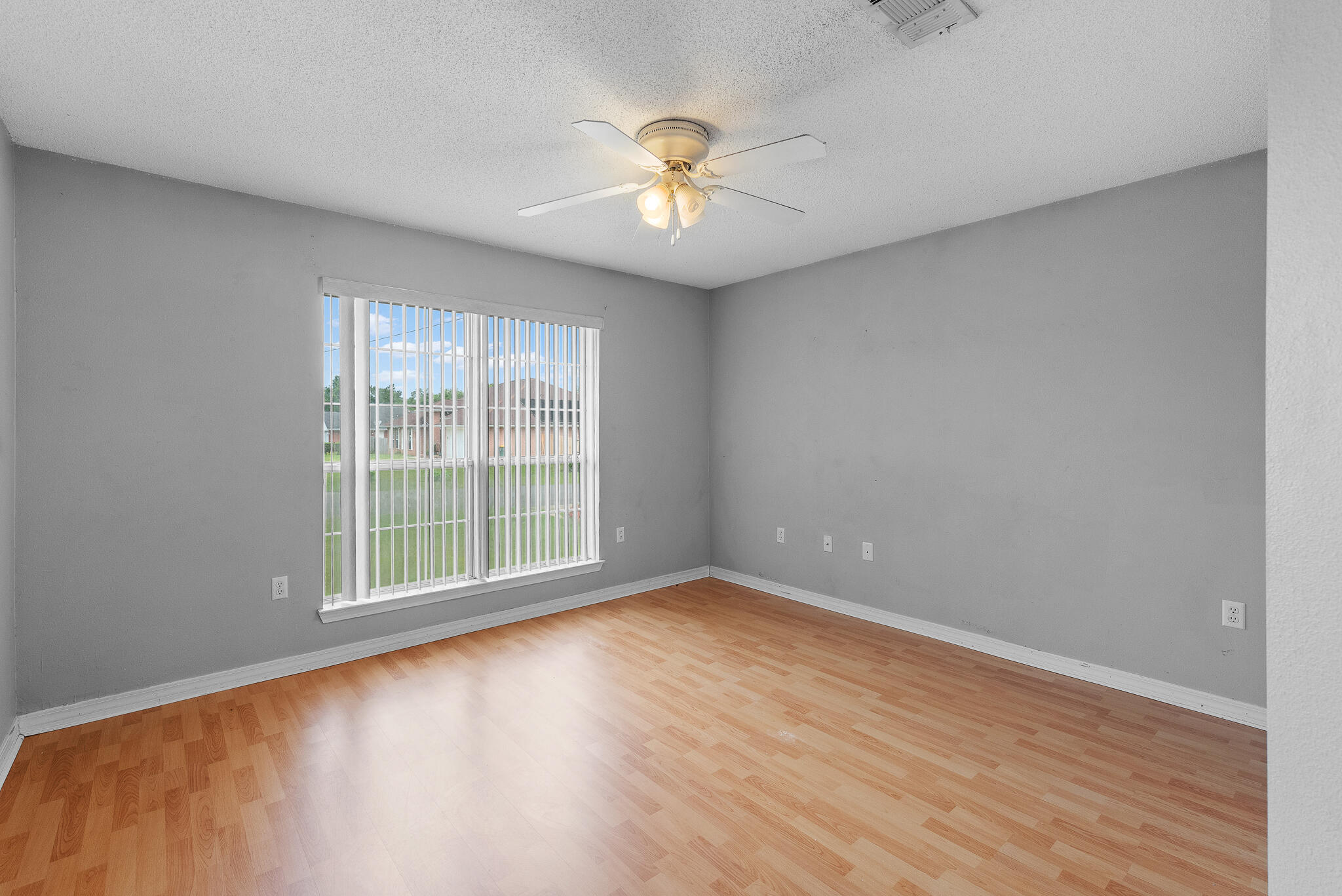 2246 Titanium Drive Crestview, FL 32536 - Photo 22 of 28 wooden floor in an empty room with a window