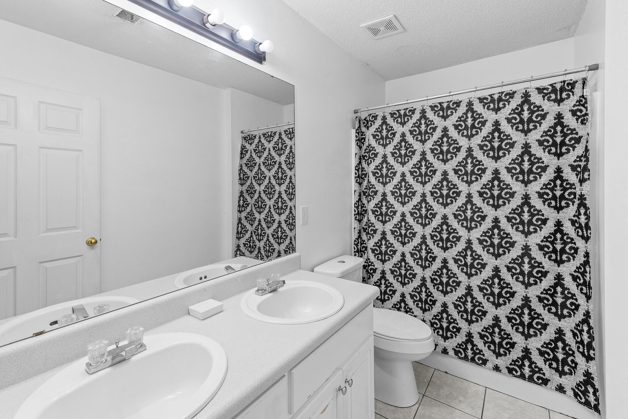 2246 Titanium Drive Crestview, FL 32536 - Photo 24 of 28 a bathroom with a sink toilet and shower