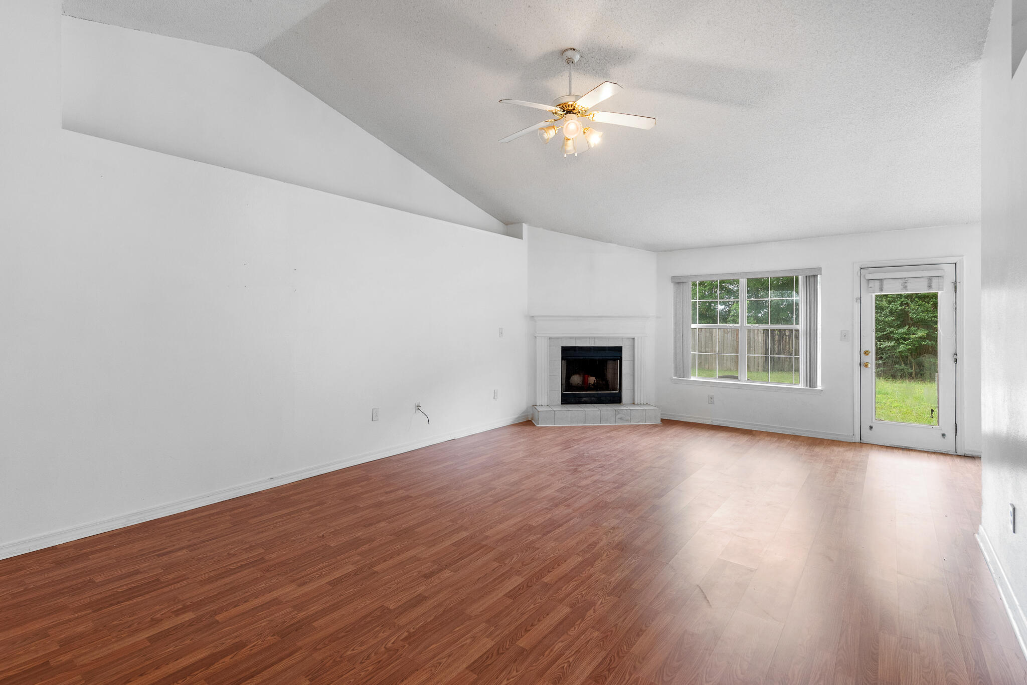 2246 Titanium Drive Crestview, FL 32536 - Photo 4 of 28 a view of an empty room with wooden floor and a window
