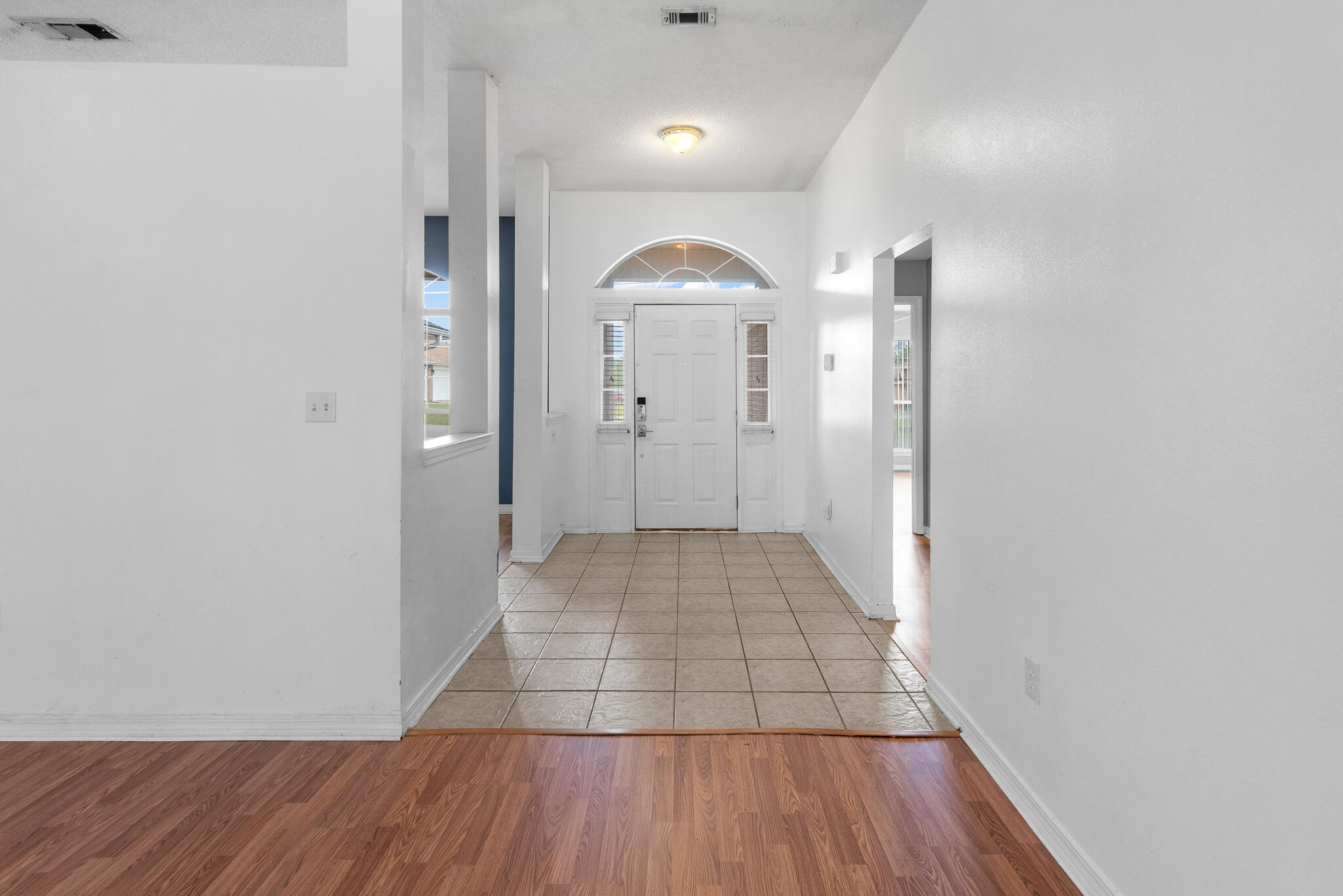 2246 Titanium Drive Crestview, FL 32536 - Photo 6 of 28 a view of a hallway with wooden floor