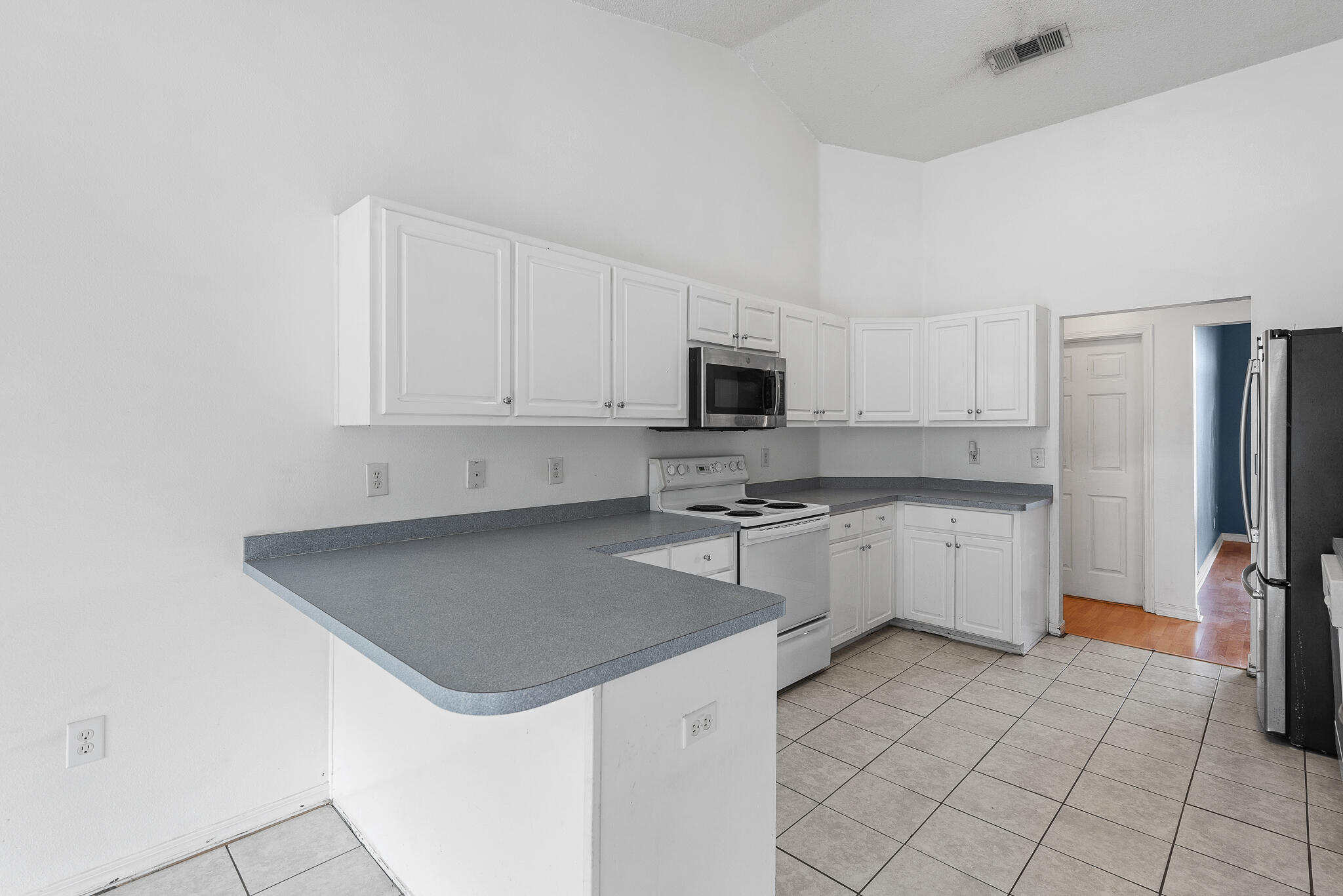 2246 Titanium Drive Crestview, FL 32536 - Photo 10 of 28 a kitchen with a stove a sink and a refrigerator