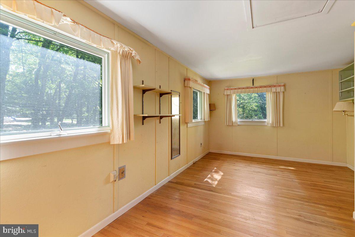 133 Woosamonsa Road Pennington, NJ 08534 - Photo 23 of 27 a view of empty room with wooden floor and fan