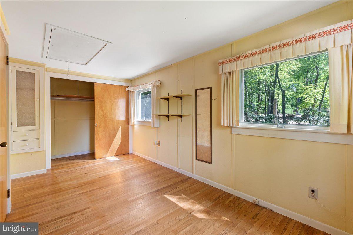 133 Woosamonsa Road Pennington, NJ 08534 - Photo 24 of 27 a view of an empty room with wooden floor and a window