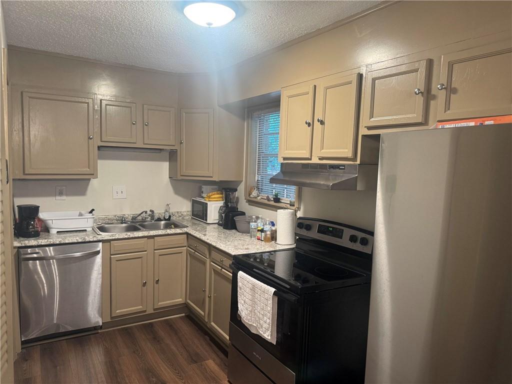 4701 Flat Shoals Road, Unit 41G Union City, GA 30291 - Photo 5 of 16 a kitchen with a sink stove and cabinets