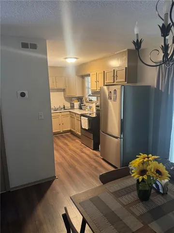a kitchen with stainless steel appliances a refrigerator and a stove