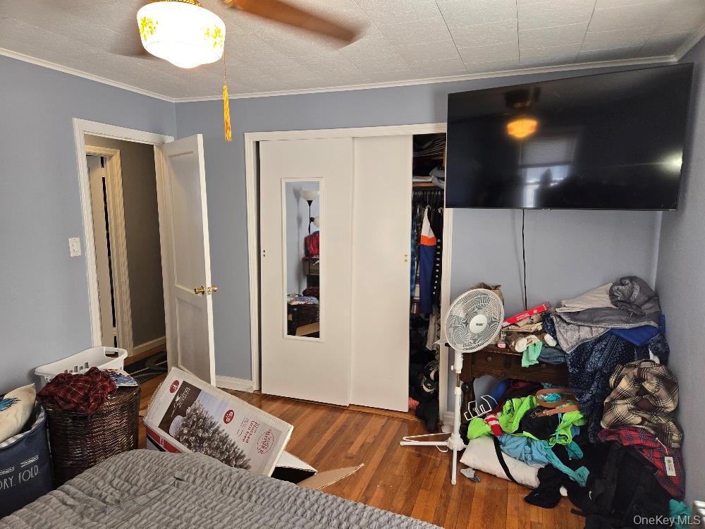 12 Carson Street Bethpage, NY 11714 - Photo 13 of 33 a bedroom with a bed and a chandelier