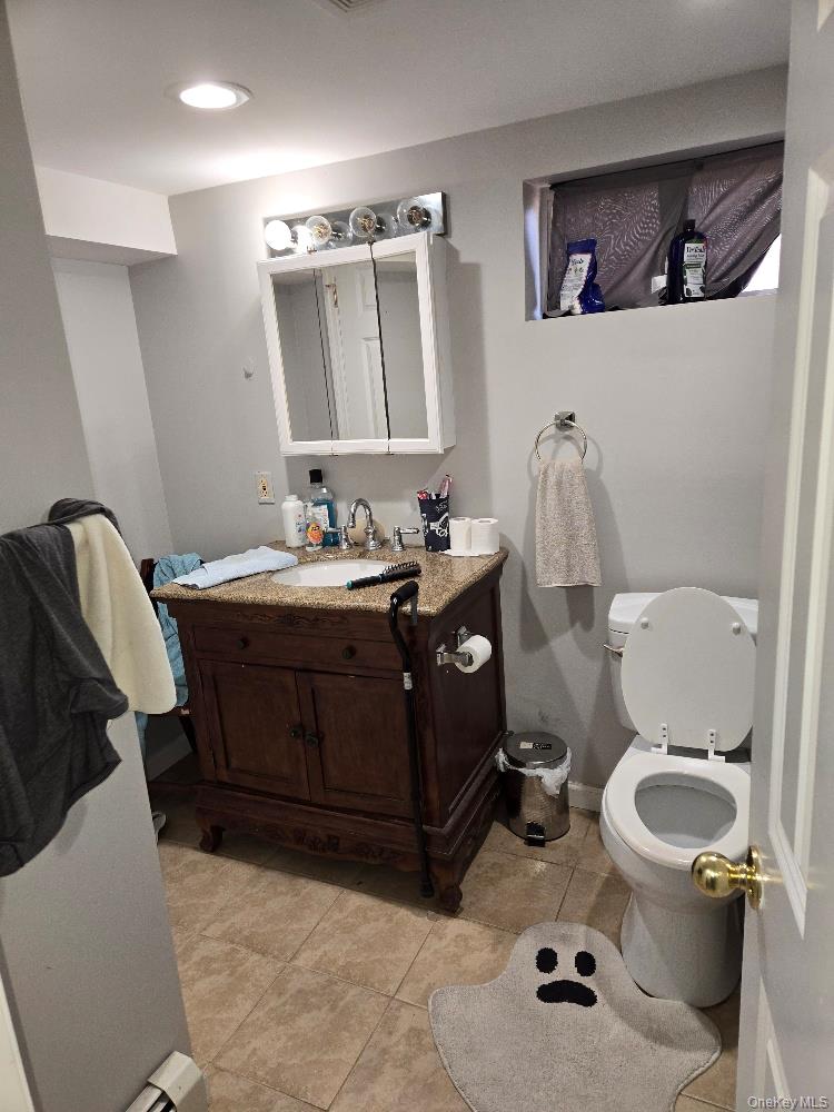 12 Carson Street Bethpage, NY 11714 - Photo 24 of 33 a bathroom with a toilet sink and mirror