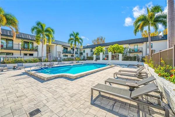 a view of a building with a swimming pool and a yard