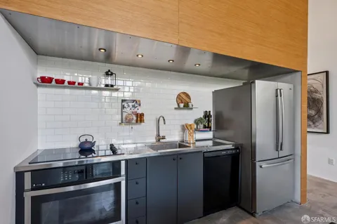 a kitchen with stainless steel appliances a sink stove and refrigerator