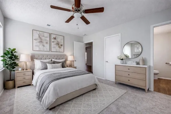 a bedroom with a bed and a dresser