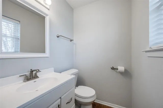 a bathroom with a sink toilet and a mirror