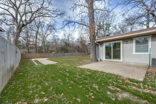 a view of a backyard with large trees
