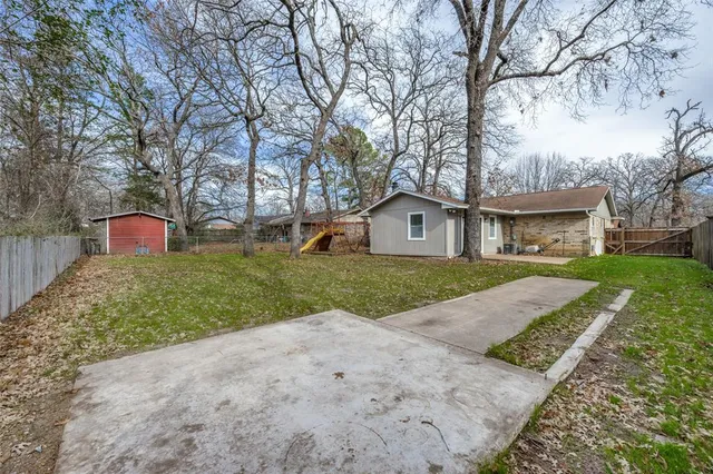 a front view of house with yard and trees