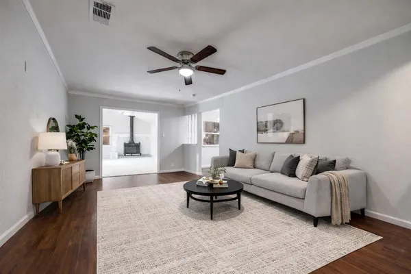 a living room with furniture and a wooden floor