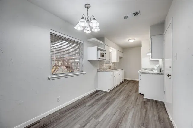 a view of a kitchen with microwave and cabinets