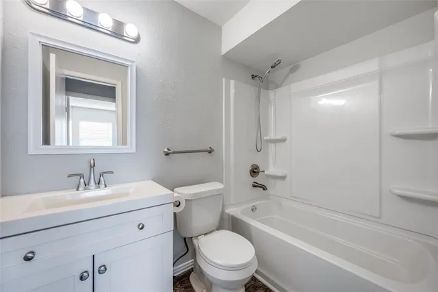a bathroom with a sink toilet a vanity and bathtub