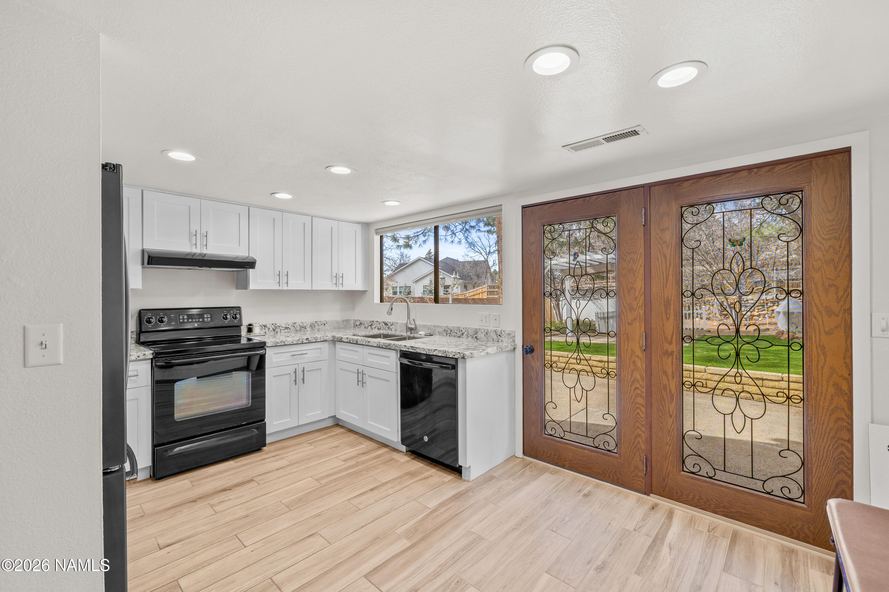 3971 North Swiss Road Flagstaff, AZ 86004 - Photo 11 of 43 a kitchen with a stove a sink and a microwave