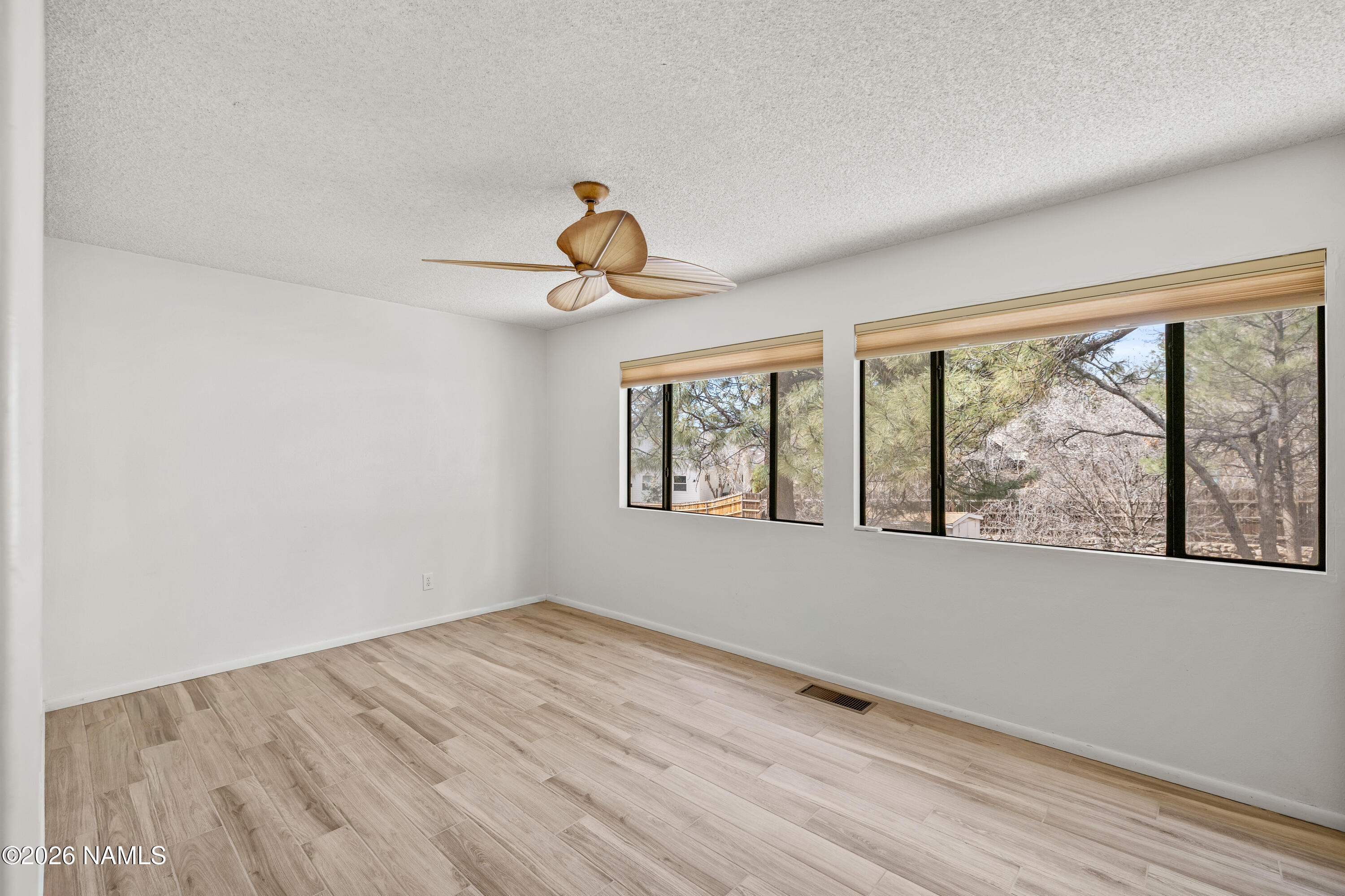 3971 North Swiss Road Flagstaff, AZ 86004 - Photo 20 of 43 wooden floor in an empty room with a window