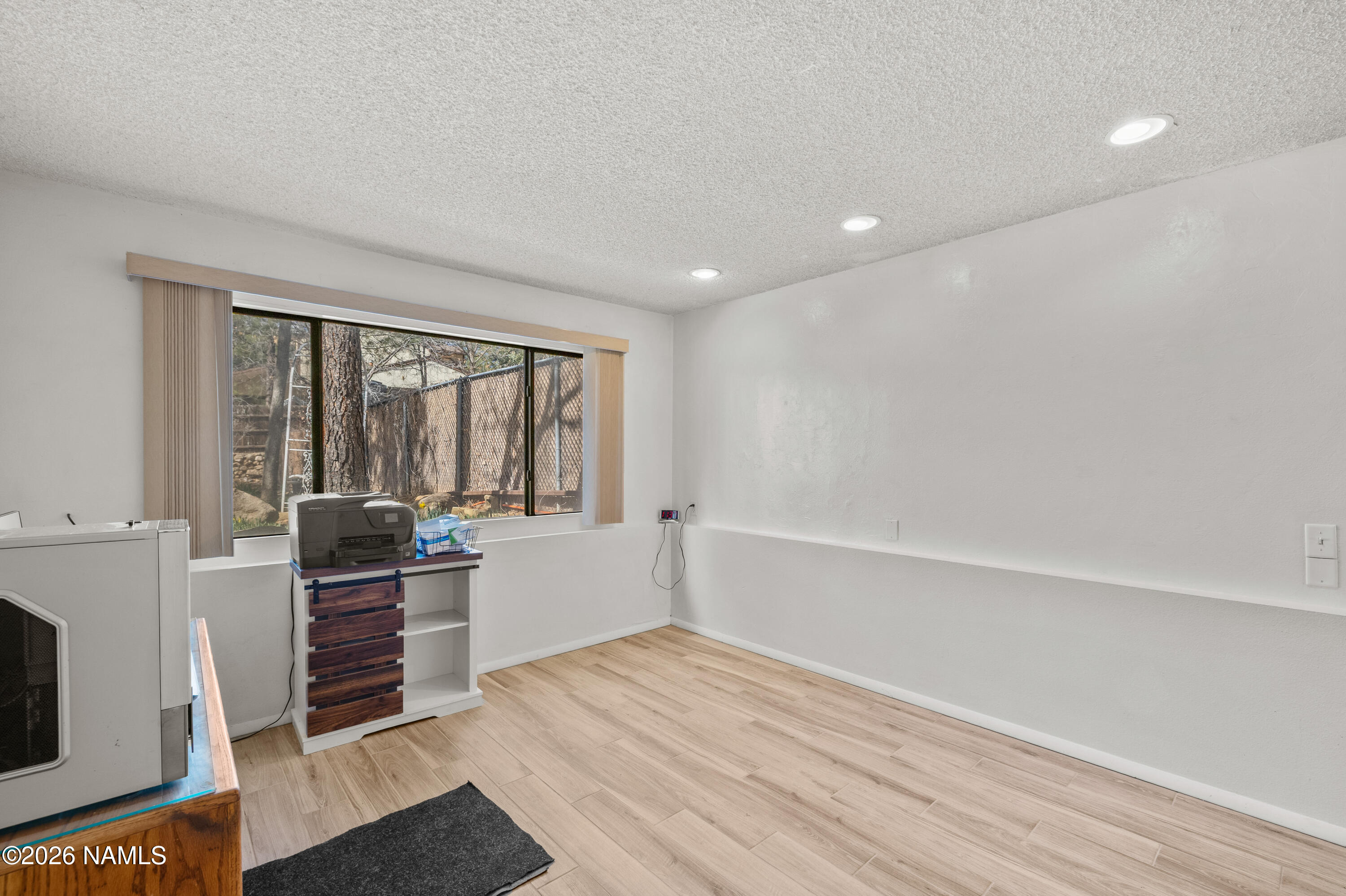 3971 North Swiss Road Flagstaff, AZ 86004 - Photo 23 of 43 a large white room with wooden floor and windows
