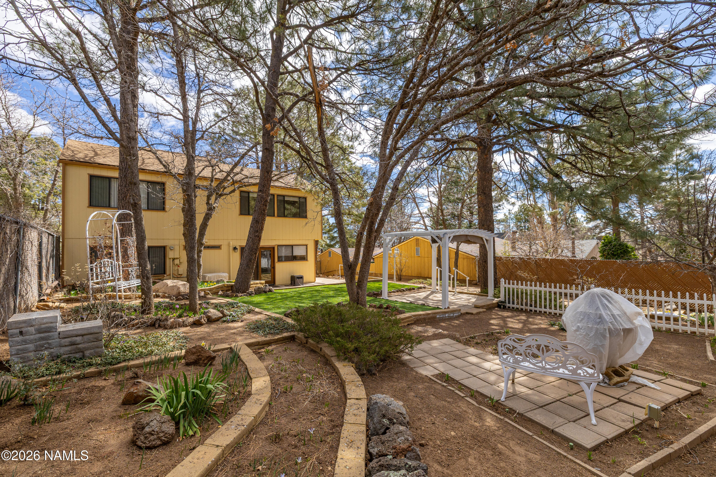 3971 North Swiss Road Flagstaff, AZ 86004 - Photo 3 of 43 a front view of a house with garden