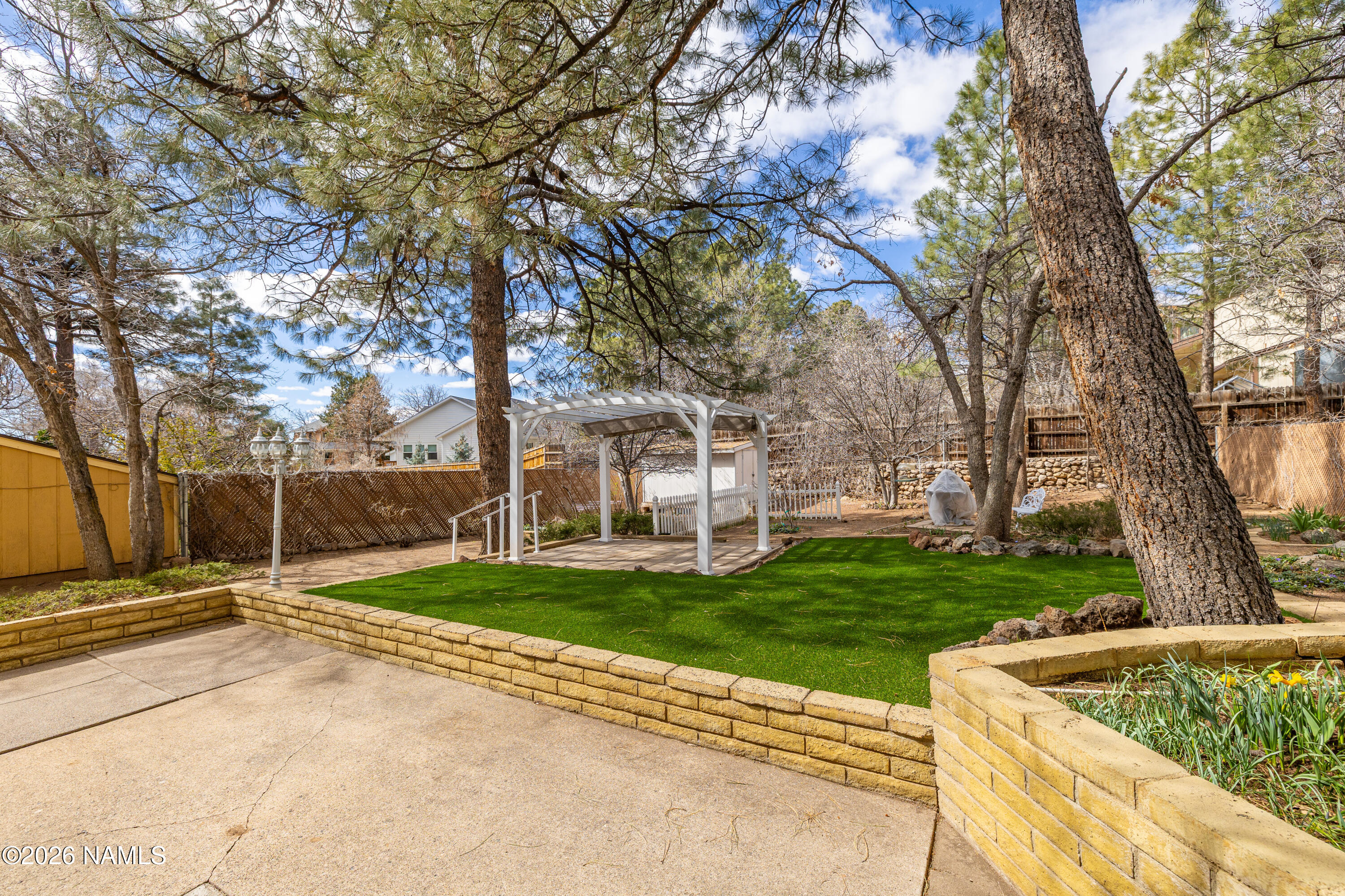 3971 North Swiss Road Flagstaff, AZ 86004 - Photo 31 of 43 a backyard of a house with lots of green space