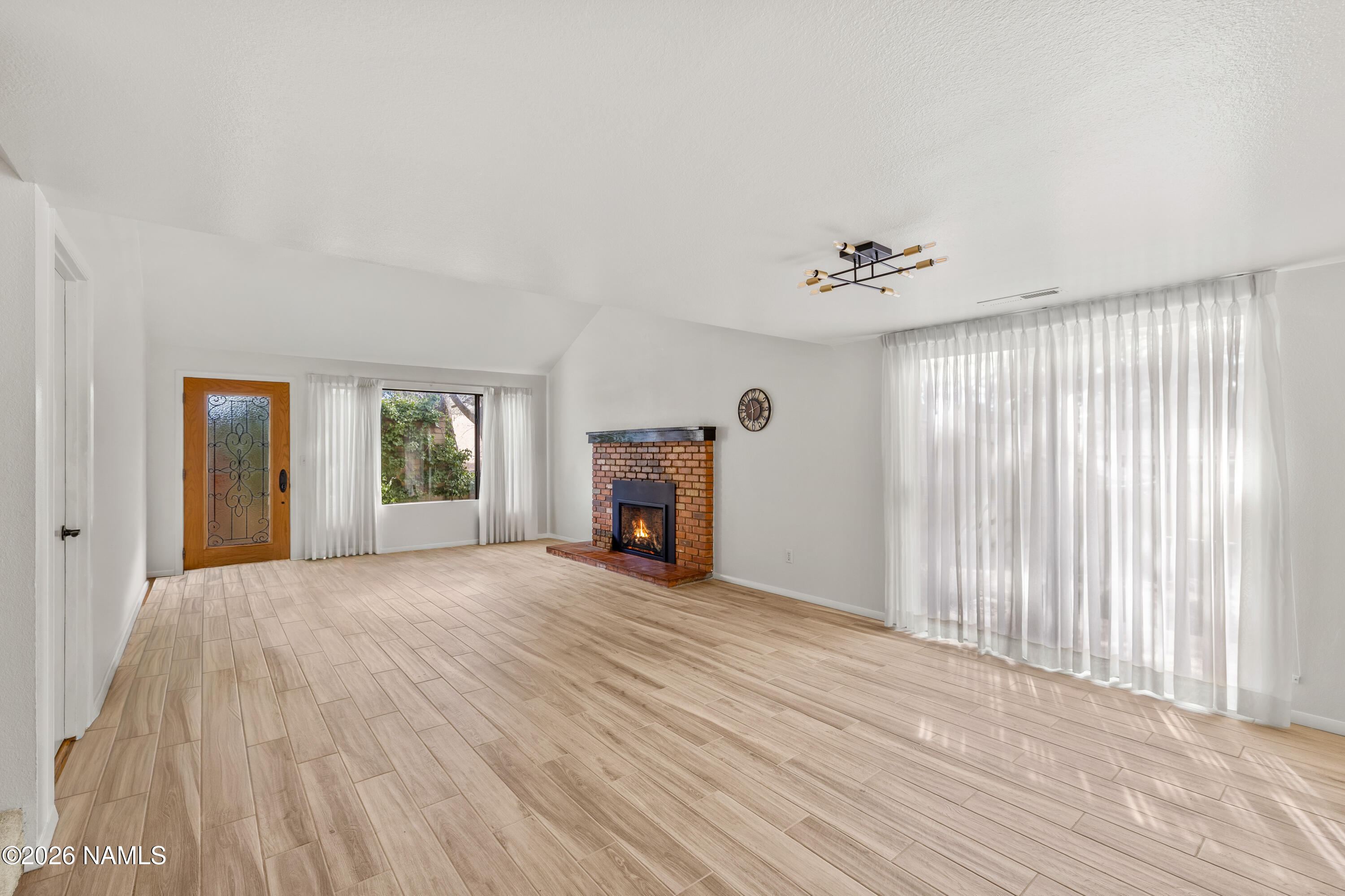 3971 North Swiss Road Flagstaff, AZ 86004 - Photo 7 of 43 a view of a livingroom with wooden floor and a ceiling fan