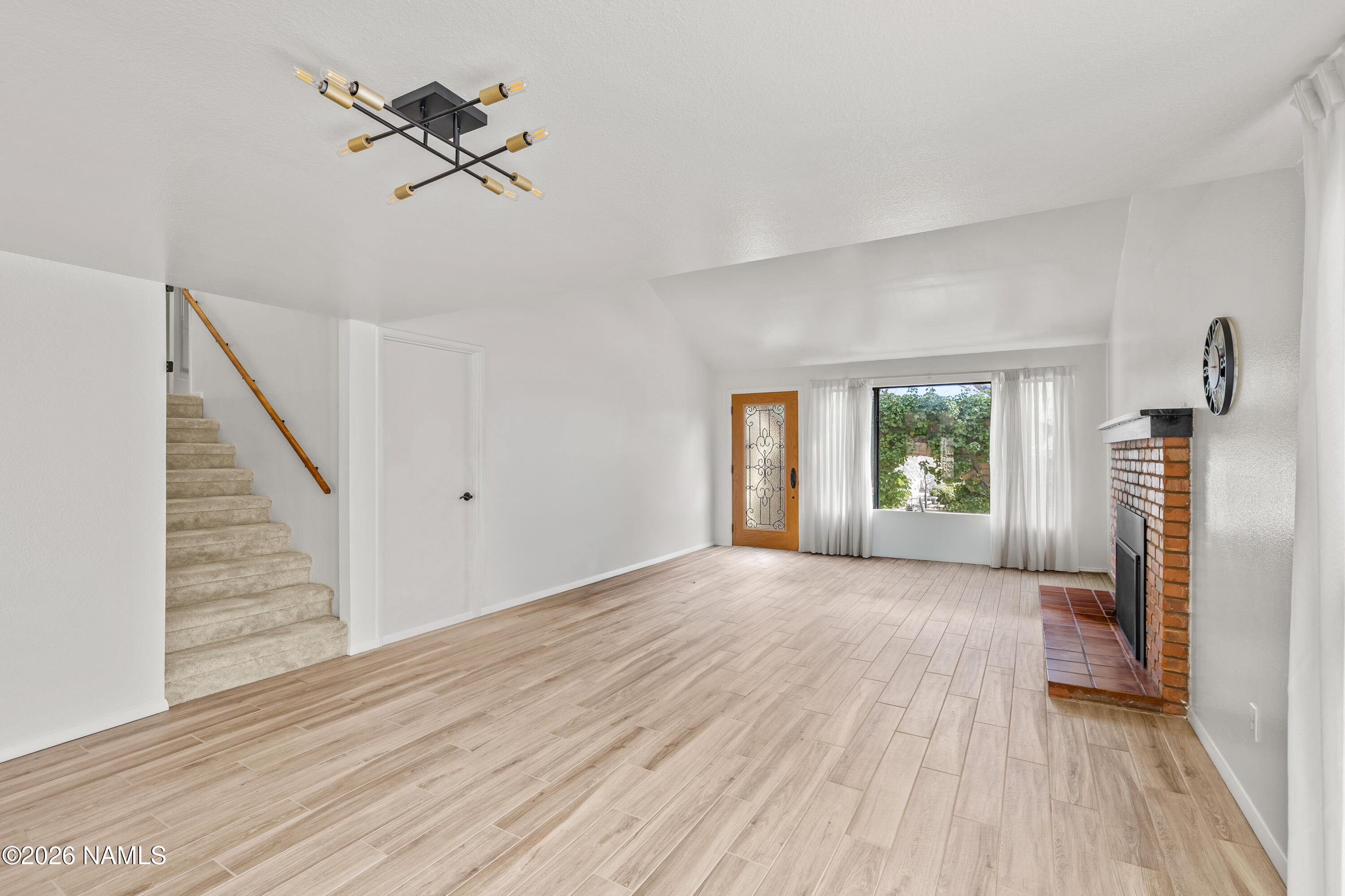 3971 North Swiss Road Flagstaff, AZ 86004 - Photo 9 of 43 a view of a livingroom with wooden floor and a ceiling fan