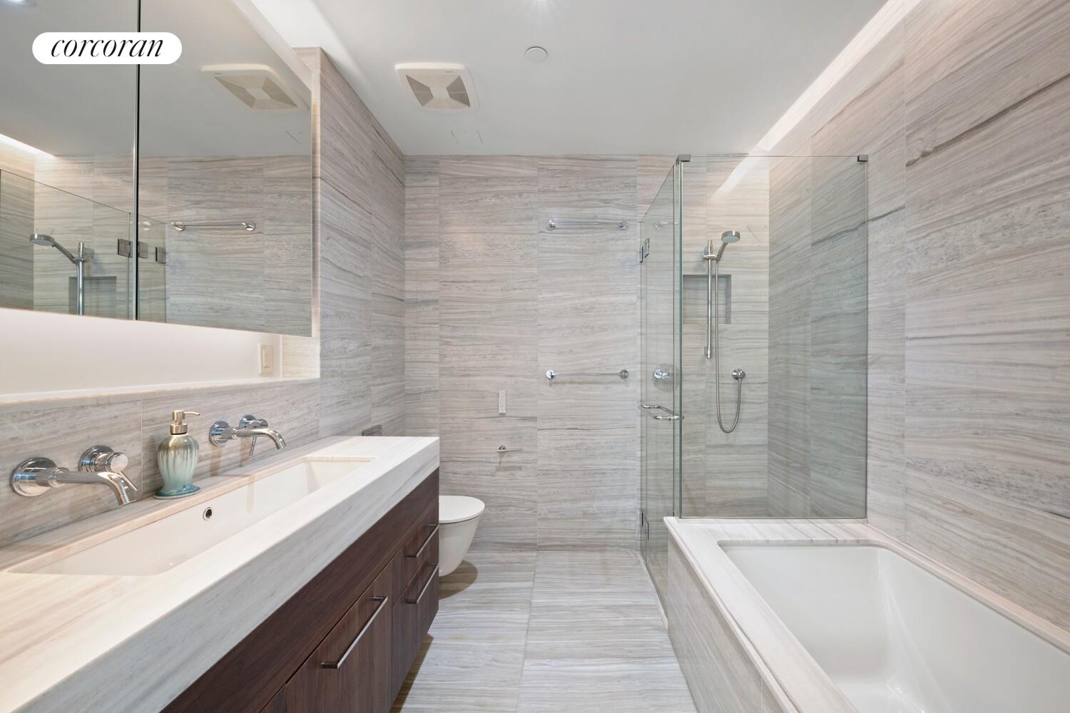 219 Hudson Street, Unit 6D Manhattan, NY 10013 - Photo 12 of 16 a bathroom with a double vanity sink and a bathtub