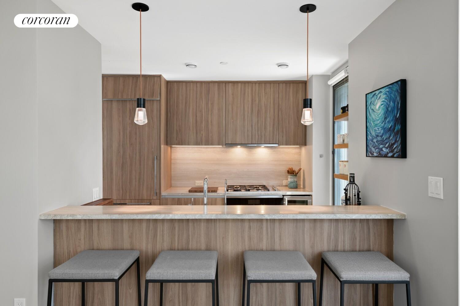 219 Hudson Street, Unit 6D Manhattan, NY 10013 - Photo 2 of 16 a kitchen with a table chairs sink and cabinets