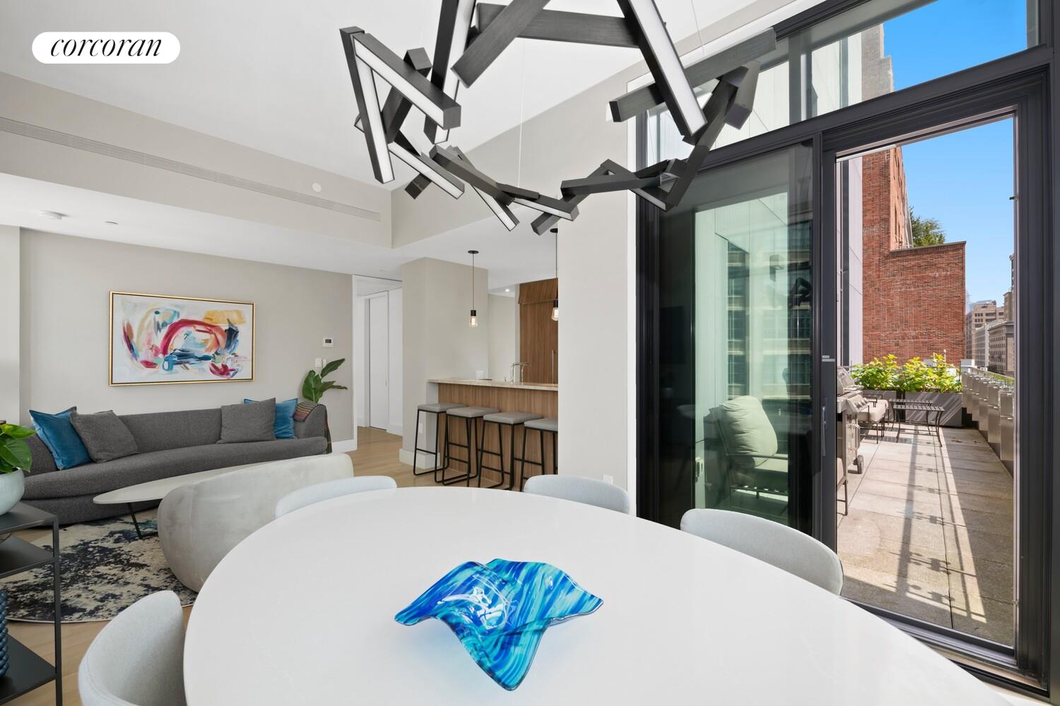 219 Hudson Street, Unit 6D Manhattan, NY 10013 - Photo 7 of 16 a living room with furniture a front door and a table