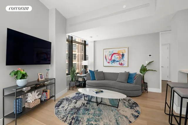 a living room with furniture a front door and a table