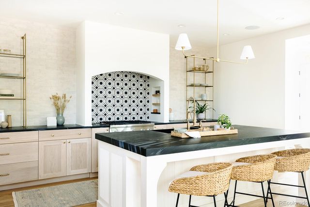 a kitchen with granite countertop a sink and cabinets