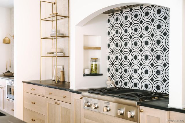 a view of a kitchen with granite countertop white cabinets and a stove