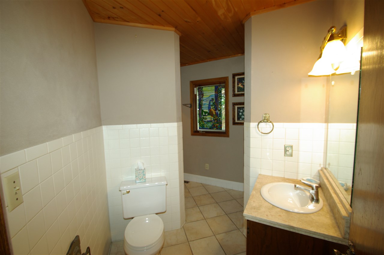 2870 West Rockton Road Rockton, IL 61072 - Photo 8 of 23 a bathroom with a granite countertop sink toilet and shower