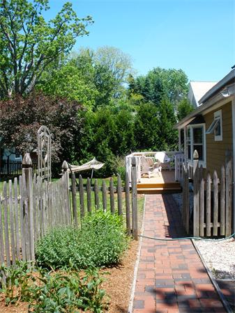 91 Ryan Road Northampton, MA 01062 - Photo 5 of 24 a view of a patio with table and chairs potted plants with wooden fence