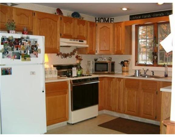 91 Ryan Road Northampton, MA 01062 - Photo 7 of 24 a kitchen with stainless steel appliances a refrigerator a sink and white cabinets